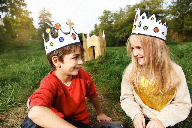 Boy and girl (6-7) wearing paper crowns
